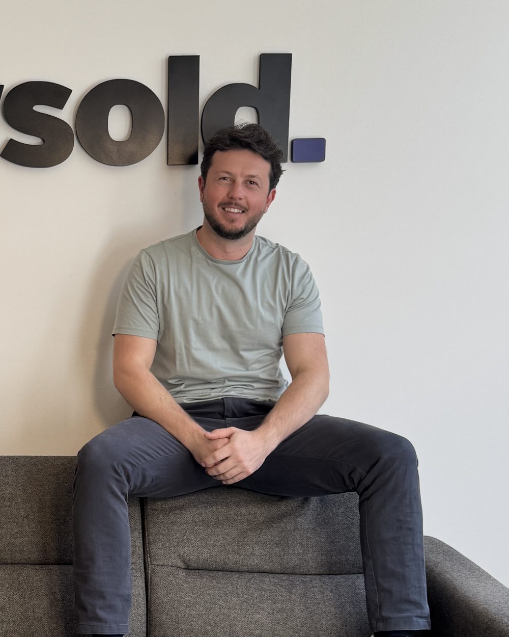 Josh Owens sitting on the office sofa